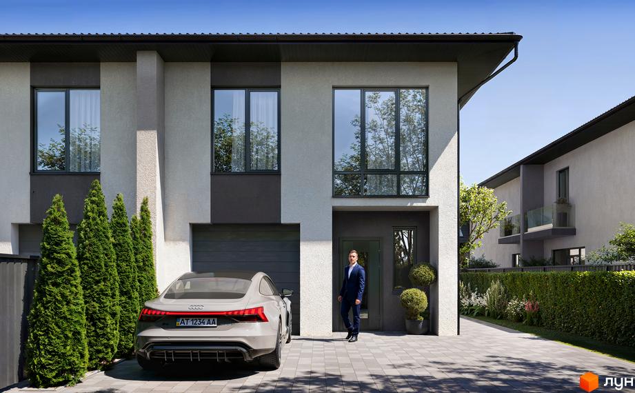 Двоповерховий таунхаус світло-сірого кольору з темними акцентами. На подвір'ї автомобіль, бруківка та зелені туї.