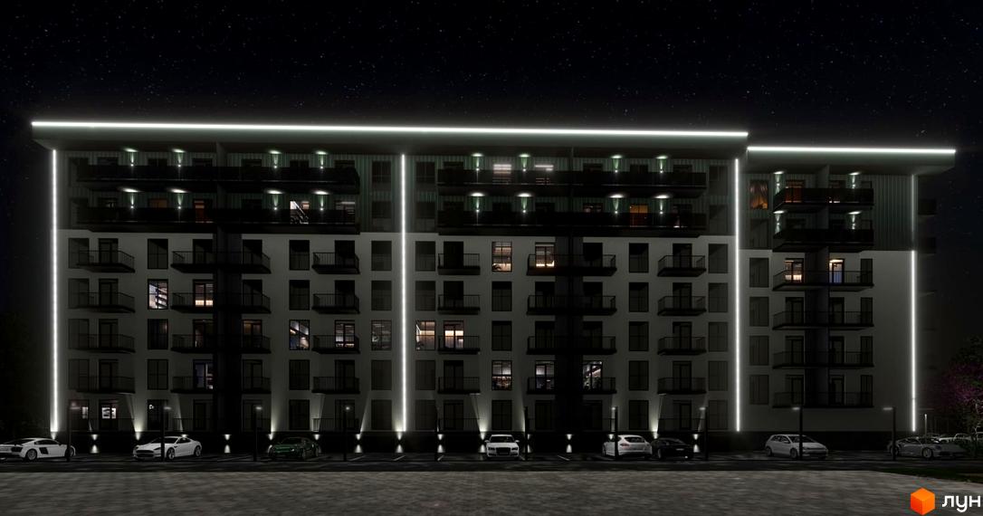Житловий комплекс Home вночі з підсвіченим фасадом та балконами. Перед будинком розташована парковка з автомобілями.