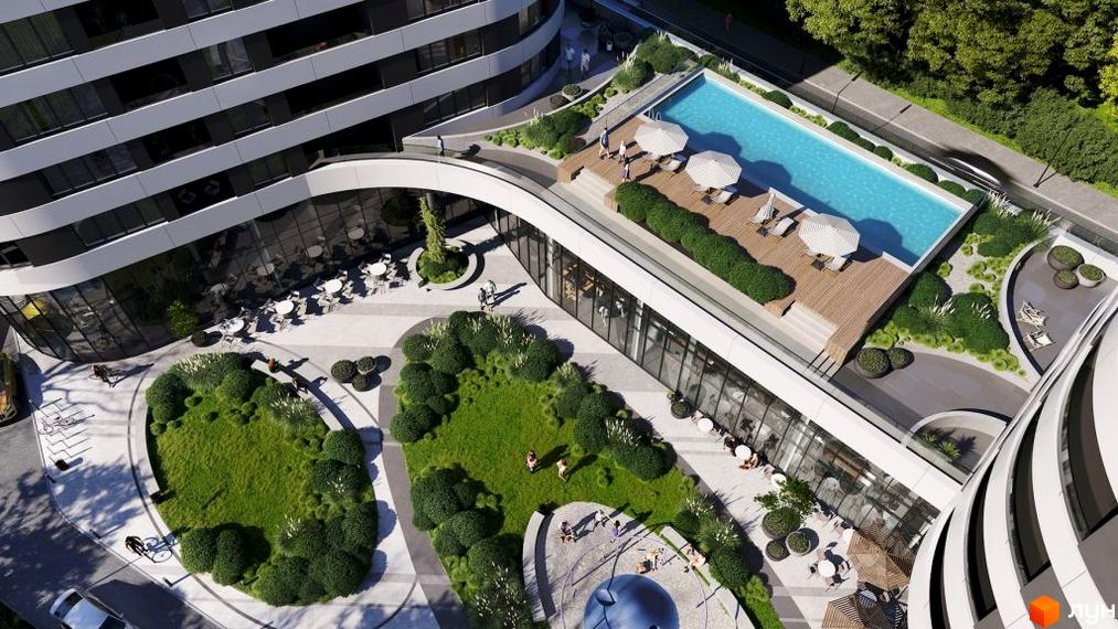 Житловий комплекс Липські вежі з вигнутими фасадами та великими вікнами. На даху розташований басейн, а на території – зелені зони та кафе.