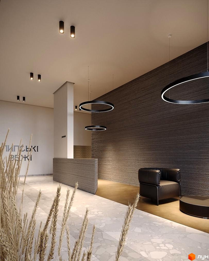Інтер'єр вестибюля Житлового комплексу Липські вежі з рельєфною стіною, підвісними круглими світильниками та декоративною травою.