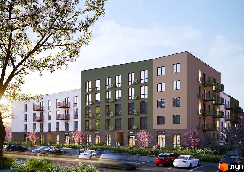 Субурбія Дуо: новобудова з фасадами різних кольорів та балконами, перед якою розташована парковка та дерева, що цвітуть.