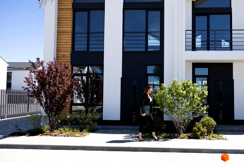 Котеджне містечко Gardd House Eco Village: будинок з білим, темним та дерев'яним фасадом, великі вікна. Територія з доріжками та деревами.