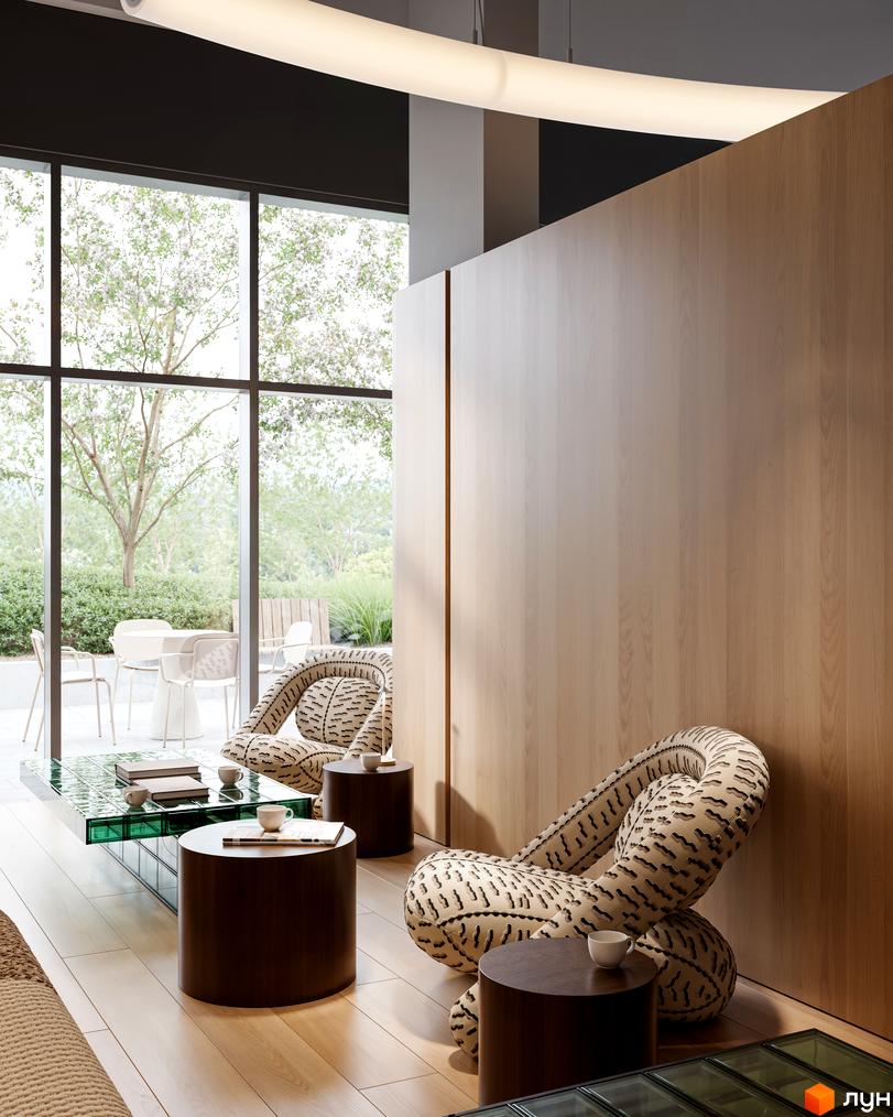 Інтер'єр Житлового комплексу Avalon Magnolia з панорамними вікнами, що відкривають вид на доглянуту прибудинкову територію з деревами.