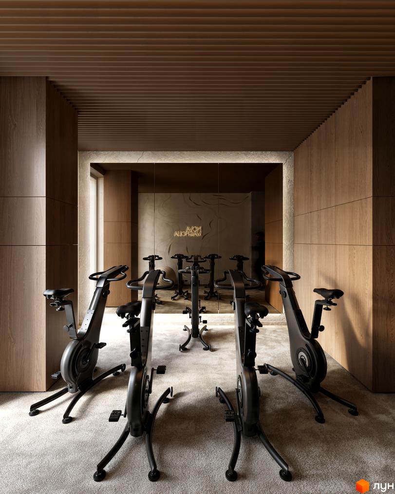 Фітнес-зал Житлового комплексу Avalon Magnolia обладнаний велотренажерами. Приміщення має дерев'яні стіни та дзеркальну поверхню.