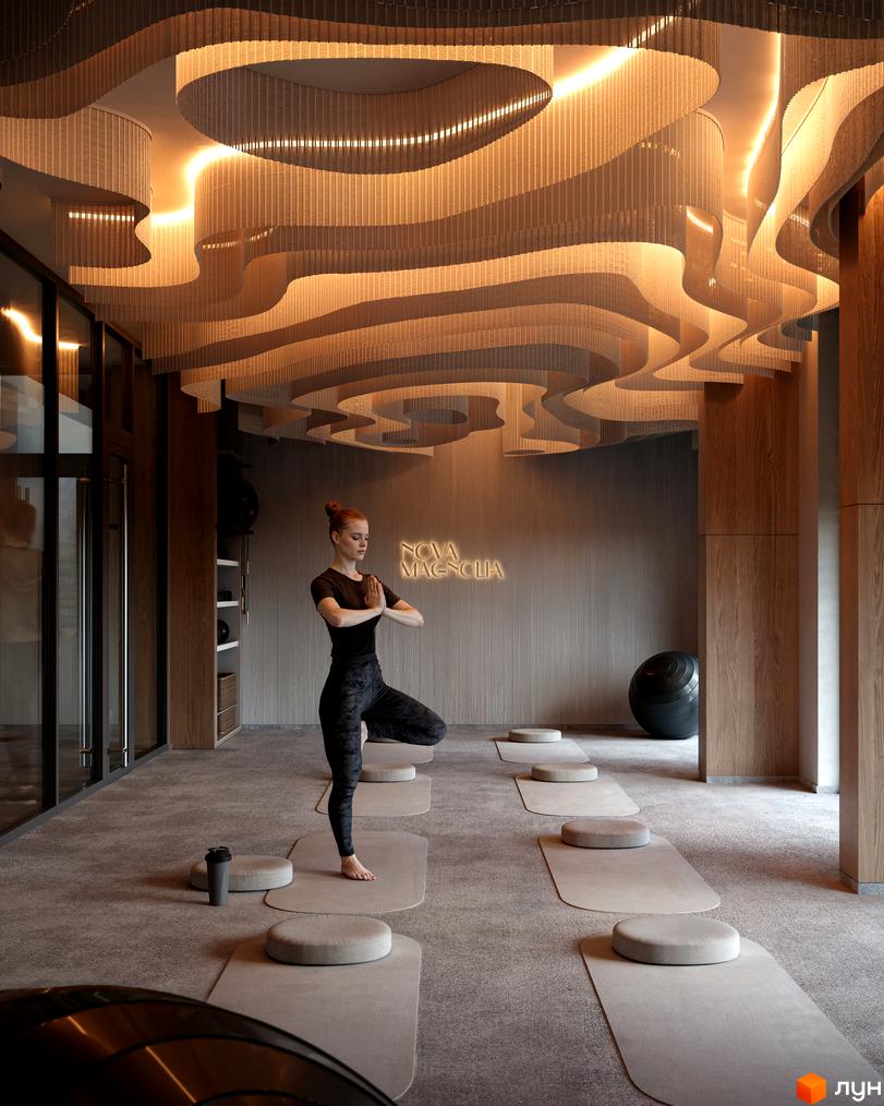 Зона для йоги у Житловому комплексі Avalon Magnolia з хвилястою стелею та теплим освітленням. Приміщення обладнане килимками та подушками.