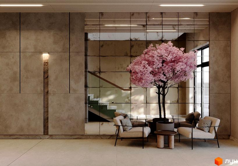Інтер'єр холу житлового комплексу на вул. Героїв Крут, 13 з кріслами, деревом та дзеркальною стіною. Сучасний дизайн та затишна атмосфера.
