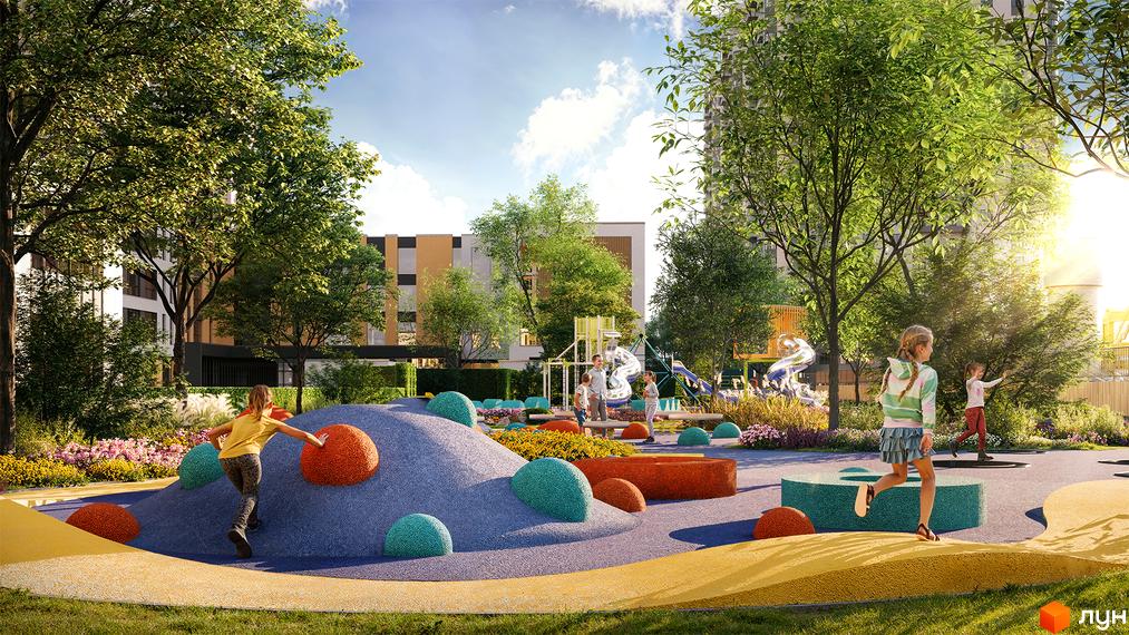 Житловий комплекс Sister: дитячий майданчик з гірками та різнокольоровими елементами на тлі сучасних будинків та зелених дерев. Територія комплексу облаштована для відпочинку дітей.