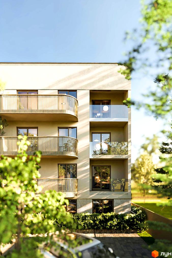 Зовнішній вигляд житлового комплексу Годинки з балконами та вікнами, оточений зеленню та деревами.