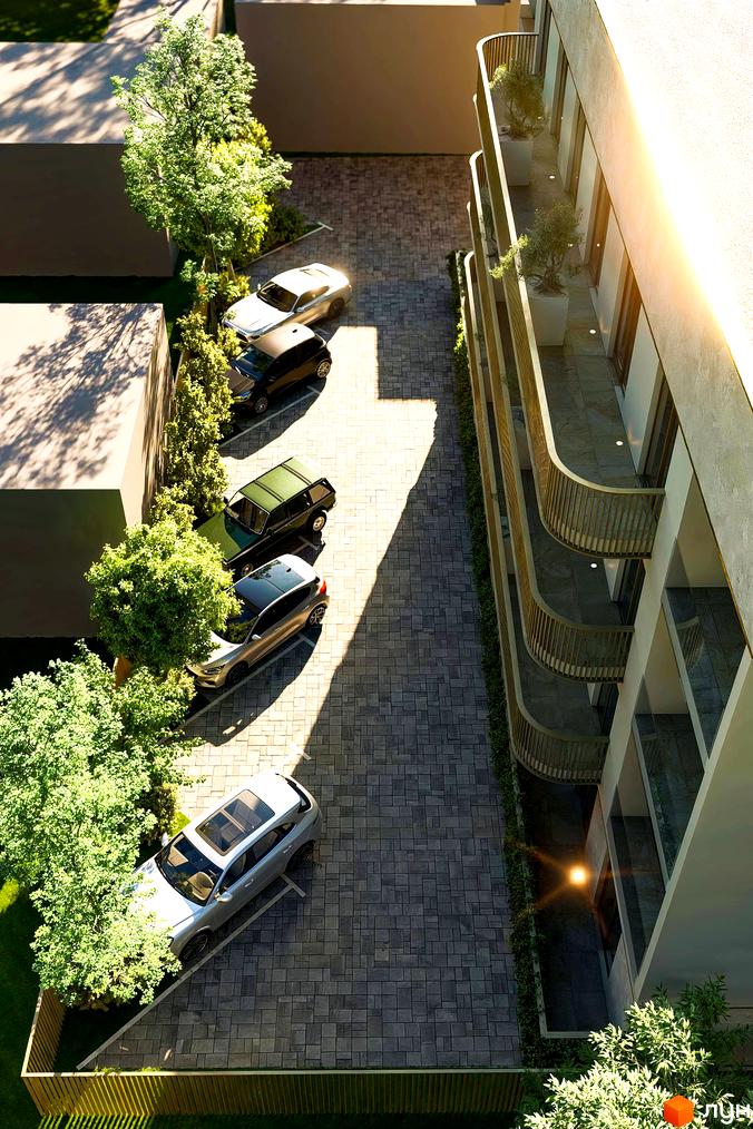 Зовнішній вигляд житлового комплексу Годинки з балконами та паркуванням автомобілів. Прибудинкова територія з деревами та газоном.