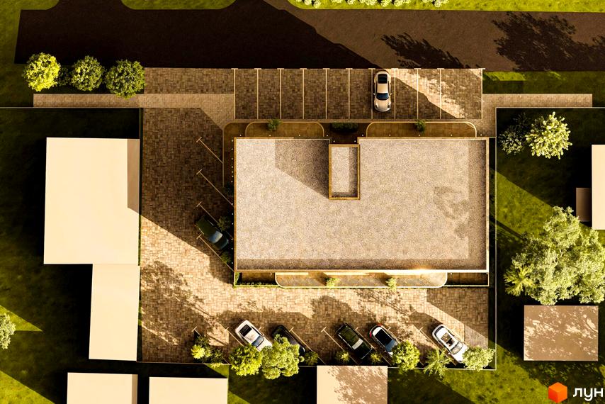 Житловий комплекс Годинки, вид зверху на будівлю з пласкою покрівлею та парковкою, оточену зеленню та деревами.