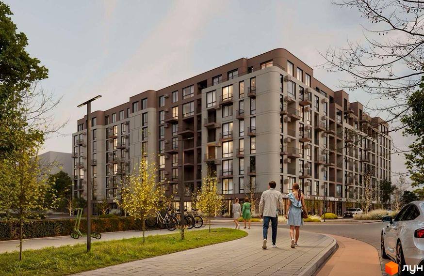 Житловий комплекс TERRA M з фасадами бежевого та коричневого кольорів та прибудинковою територією з деревами та пішохідною доріжкою.