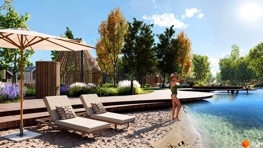 Котеджне містечко Piemont eco village: зона відпочинку біля озера з шезлонгами та парасолькою. Навколо зелені дерева та сучасні дерев'яні конструкції.