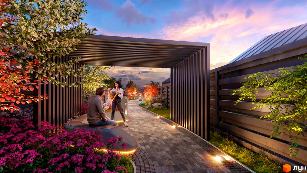 Котеджне містечко Piemont eco village. Пара закоханих насолоджується вечірнім краєвидом біля перголи з квітучими деревами та декоративними рослинами.