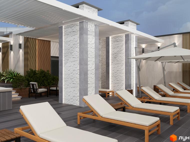 Тераса Комплексу Breeze Marine з перголою, кам'яними колонами та дерев'яними лежаками. Зона відпочинку з парасольками та зеленню.