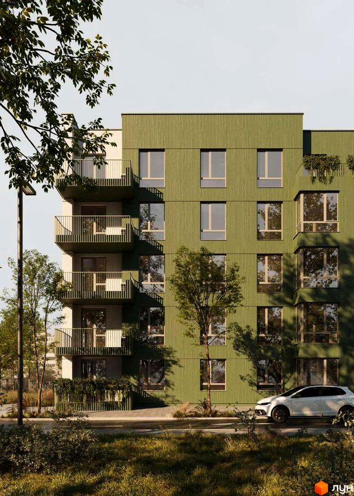 Новобудова ЖК Смарагд з зеленим фасадом та балконами. Навколо будівлі дерева та зелена прибудинкова територія.
