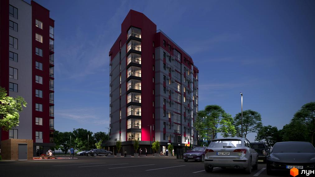 Житловий комплекс GRAND Липини ввечері: багатоповерховий будинок з червоно-сірим фасадом, освітлені вікна та парковка з автомобілями.