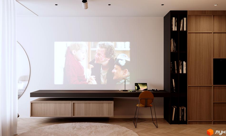 Вітальня з проєктором у житловому комплексі Standard One Nyvky. Інтер'єр з робочим столом, книжковою шафою та дерев'яними елементами.