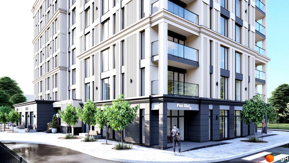 Новобудова Андріївський: багатоповерховий будинок зі світлим фасадом та темним низом. Навколо тротуари, дерева та магазин Fox Hol.