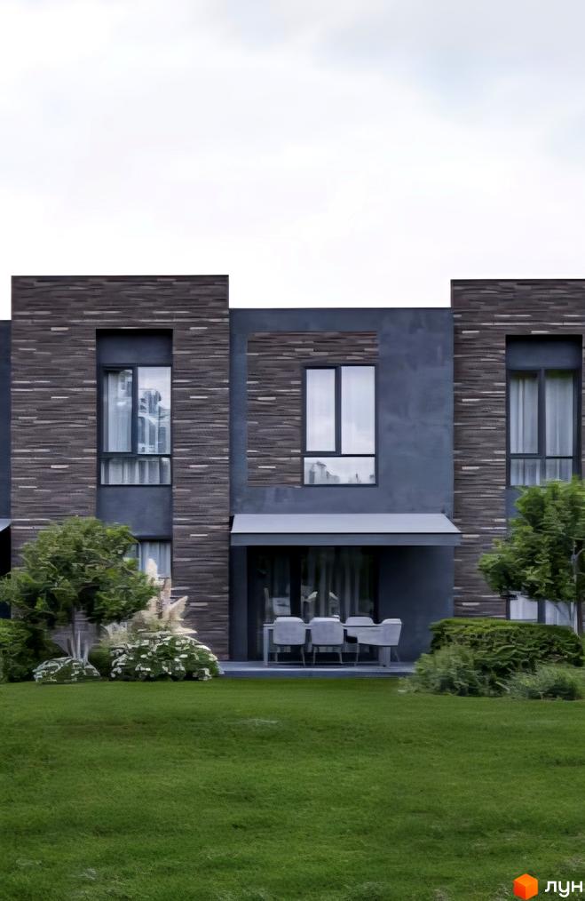 Таунхауси Town BOX – двоповерхові будинки з темною цегляною обробкою та великими вікнами, розташовані на зеленій галявині з кущами та деревами.