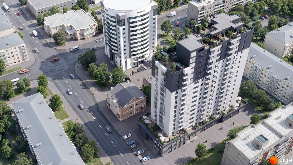 Житловий комплекс Дім на Грушевського з біло-сірими фасадами та терасами, оточений деревами та міською забудовою.