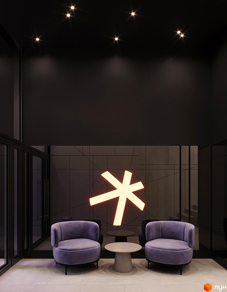 Житловий комплекс Зоряні: затишна зона відпочинку з двома кріслами та столиком біля неонового логотипу.