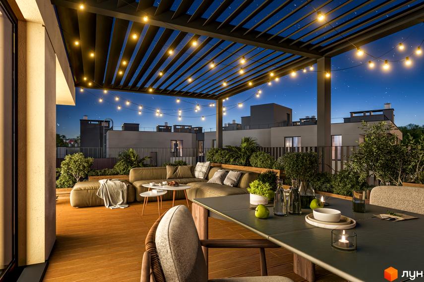 Тераса житлового комплексу MHouse з вечірнім освітленням та меблями на тлі нічного неба та сусідніх будинків.