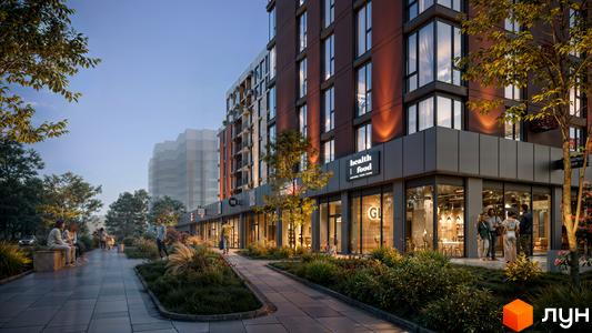 Житловий комплекс SVOÏ INSPIRO з фасадами темного кольору та великими вікнами, поруч доглянута прибудинкова територія з деревами та місцями для відпочинку.