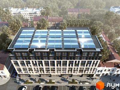 БФК Shevchenka 58a з сонячними панелями на даху та прилеглою територією з деревами та парковкою. Зовнішній вигляд будинку з цегляним фасадом та великими вікнами.