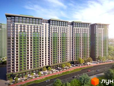 Житловий комплекс LIKO-GRAD Perfect Town з зеленими та білими фасадами, балконами та великими вікнами. Поруч дорога з автомобілями та зелені насадження.