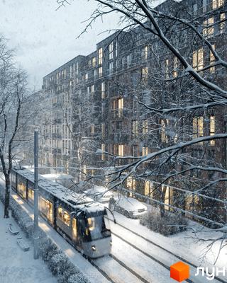 Житловий комплекс Avalon Yard у зимовий період з трамваєм та засніженими деревами. Сучасна архітектура будівель та затишна прибудинкова територія.