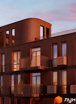Житловий комплекс Avalon Terra з коричневим фасадом та затишними балконами на заході сонця. Будинок має незвичайну округлу форму верхньої частини та великі вікна.