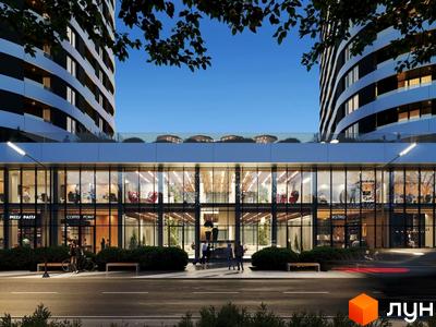 Житловий комплекс Липські вежі з двома високими будинками та комерційними приміщеннями на першому поверсі. Перед будівлею облаштована пішохідна зона з лавками та зеленню.