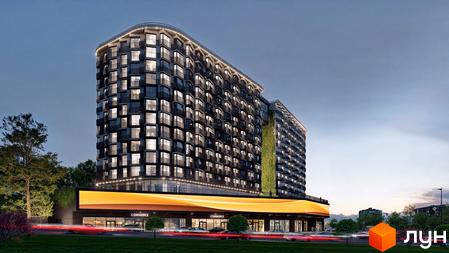 Сучасний житловий комплекс з фасадом з вікон та балконів, зеленою стіною та комерційними приміщеннями на першому поверсі. Навколо будинку дерева та освітлена дорога.