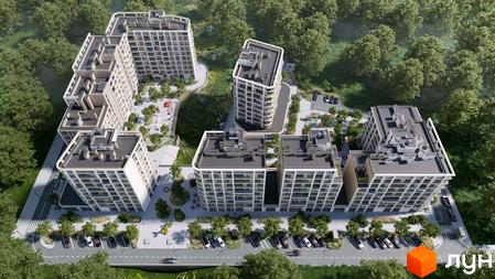 Житловий комплекс ШЕЛЕСТ: аерофотознімок будинків зі світлими фасадами та округлими формами, розташованих серед лісу з парковками та дитячими майданчиками.