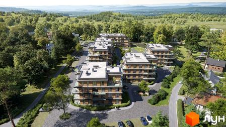 Житловий комплекс AURA з багатоповерховими будинками та балконами, оточений зеленими насадженнями та парковками. Вид зверху на забудову серед пагорбів.