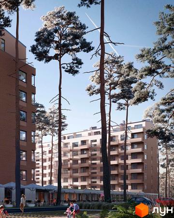 Житловий комплекс Wellness Park з цегляними фасадами та балконами, оточений високими соснами. На прибудинковій території розташовані кафе та зелені зони.
