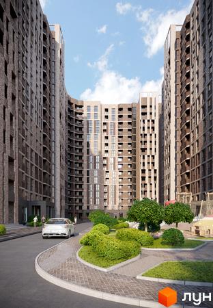 Прохоровський квартал: фасади будинків з цегляним оздобленням та балконами, упорядкована прибудинкова територія з кущами та деревами.