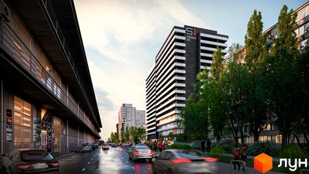 Зображення фасаду ЖК Standard One Obolon. Багатоповерховий будинок з балконами та великими вікнами, поруч зелені дерева та дорога з автомобілями.