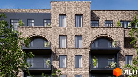 Клубний будинок LOFT EGOIST має цегляний фасад з темними балконами, арковими та прямокутними вікнами. Навколо видно зелені дерева.