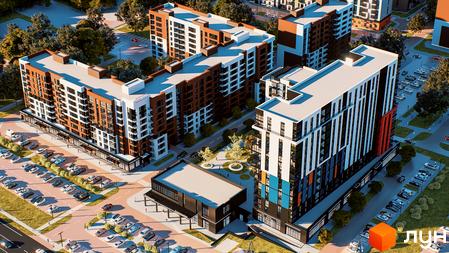 Зображення комплексу Prime Tower з висоти пташиного польоту. Видно багатоповерхові будинки та парковку з великою кількістю машин.