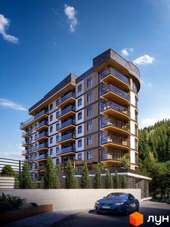 Skelya Residence - сучасний житловий комплекс з вигнутим фасадом, скляними балконами та підсвіткою. Навколо будинку зелена зона та зручний під'їзд.